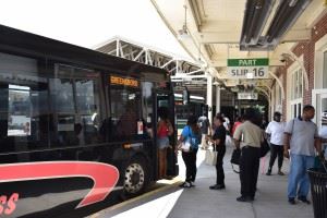 People boarding PART bus at station